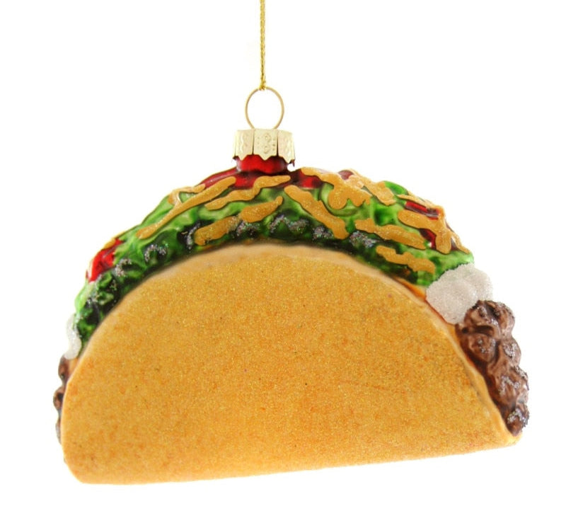Taco-shaped ornament with a gold hook on a white background