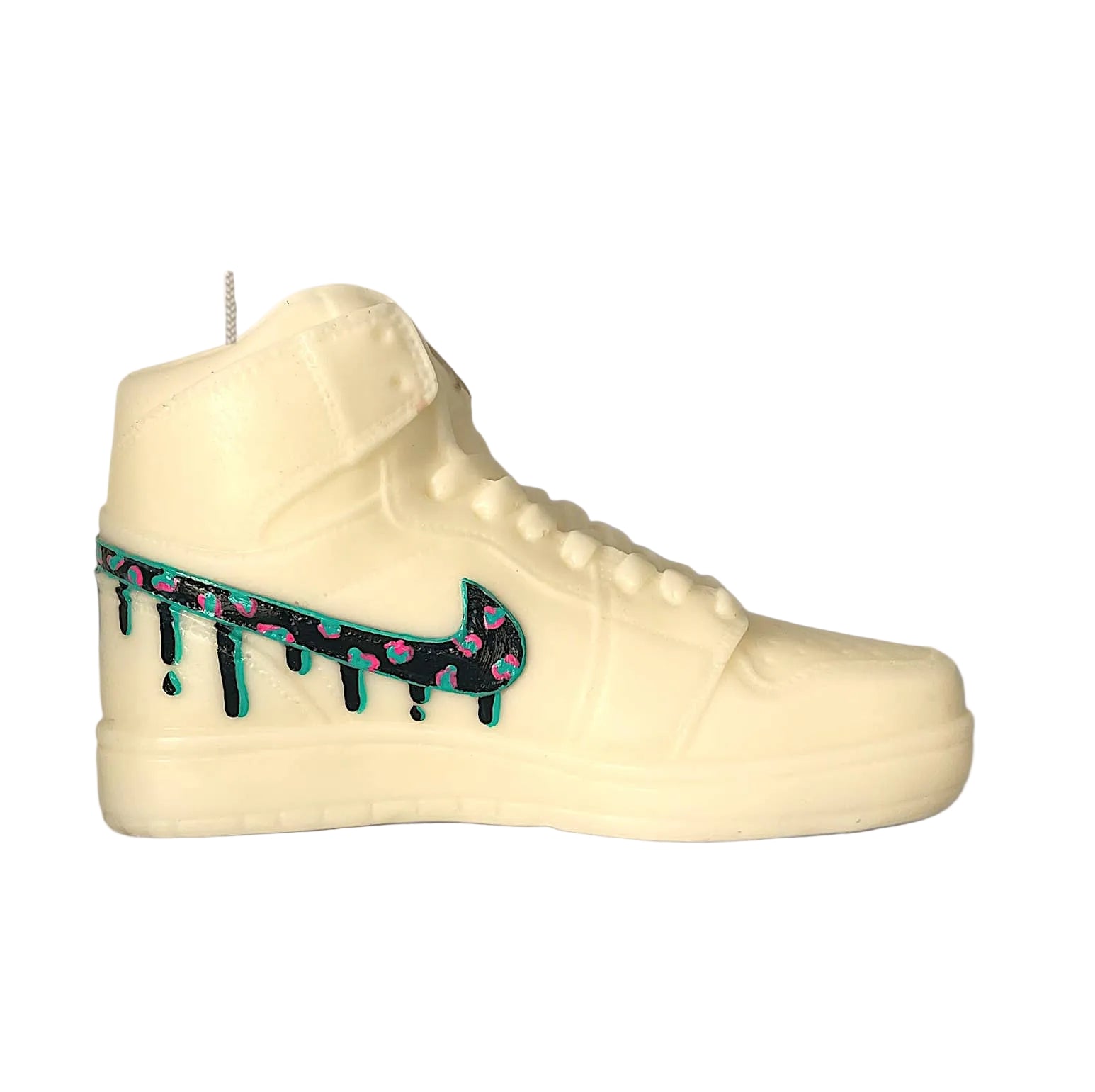 White sneaker-shaped candle with a colorful nike swoosh logo on a white background