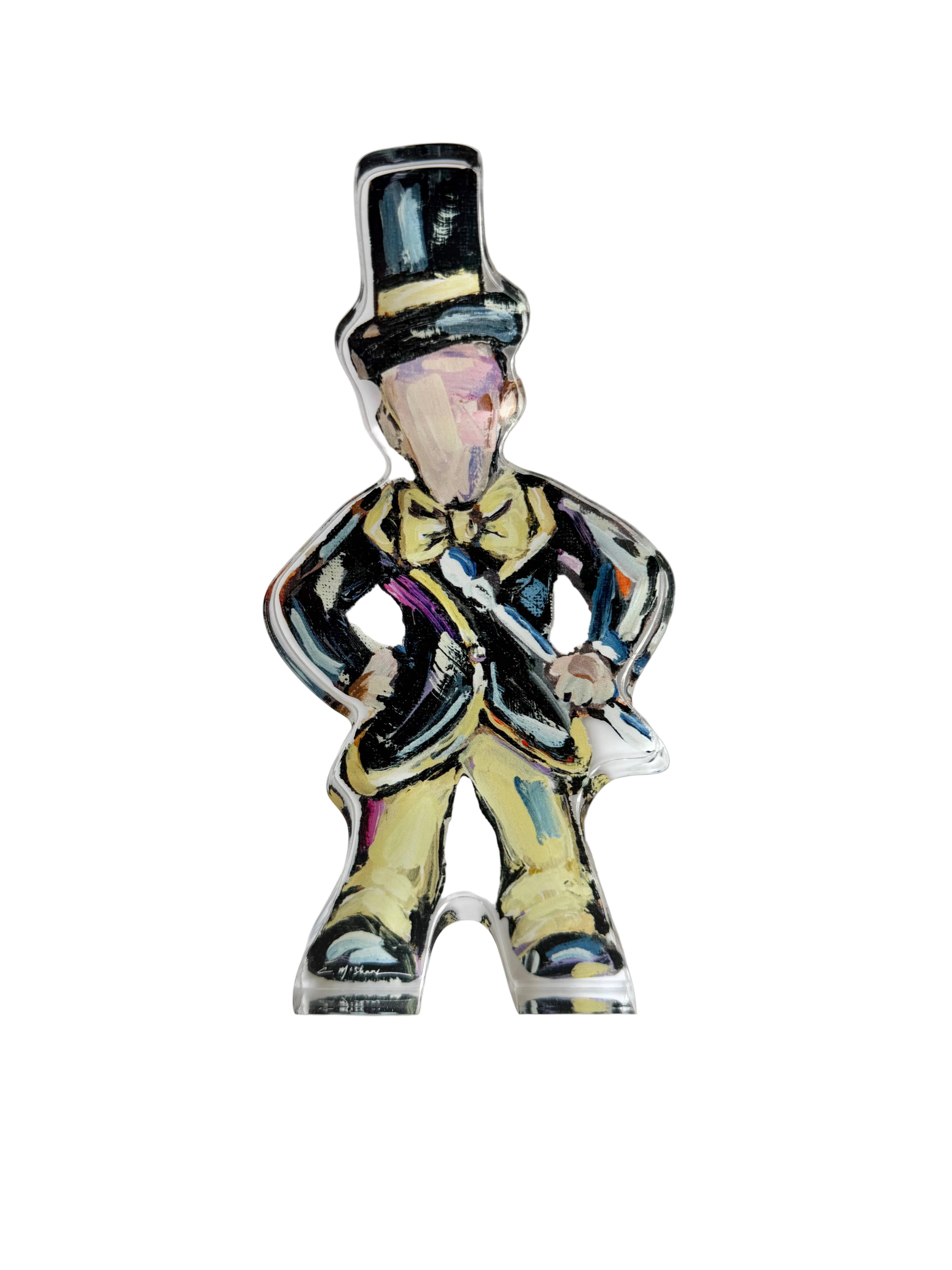 Colorful figurine of a man in a top hat and suit on a white background