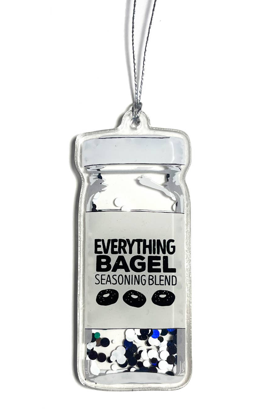 Decorative ornament shaped like a bagel seasoning container with colorful sprinkles on a white background