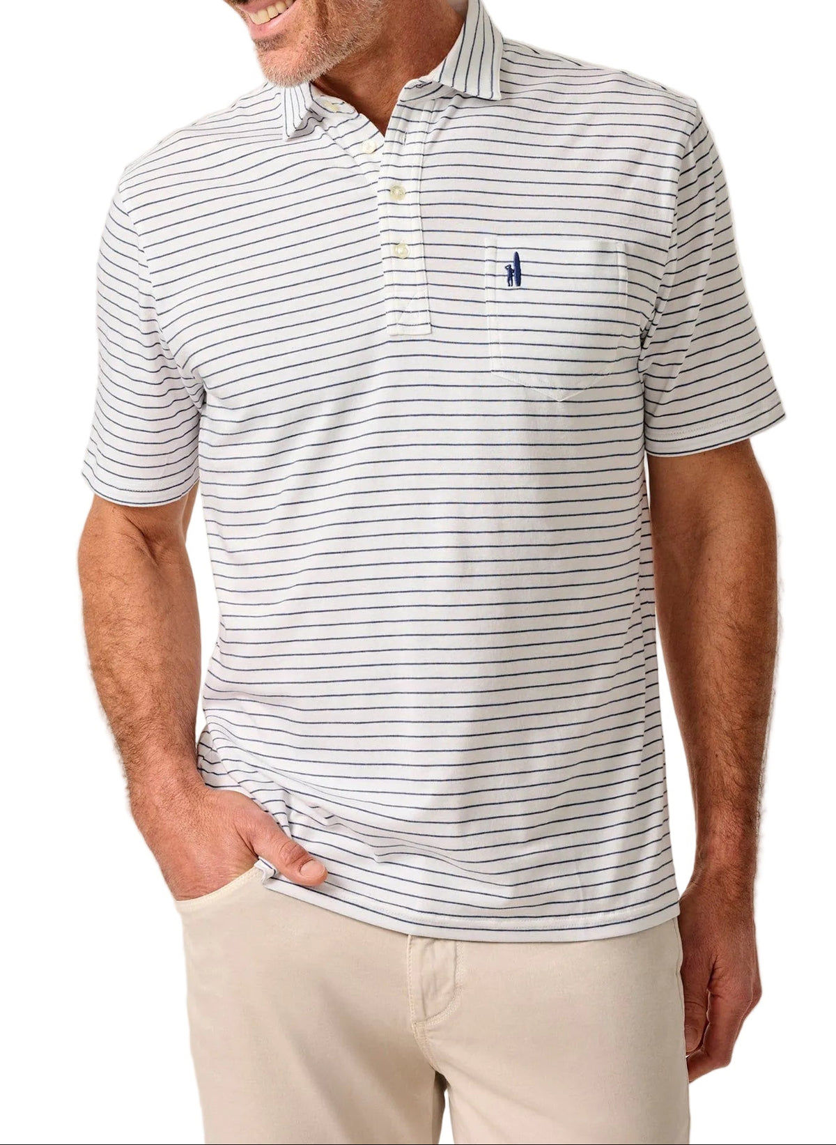 Man wearing a striped polo shirt with a logo on a beige background
