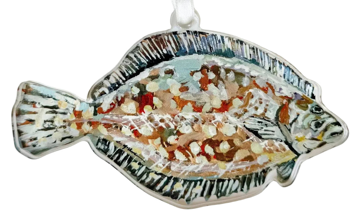 A decorative fish-shaped ornament with a white hanging ribbon, featuring a textured multicolor design with blue, green, orange, and cream details on a plain white background.