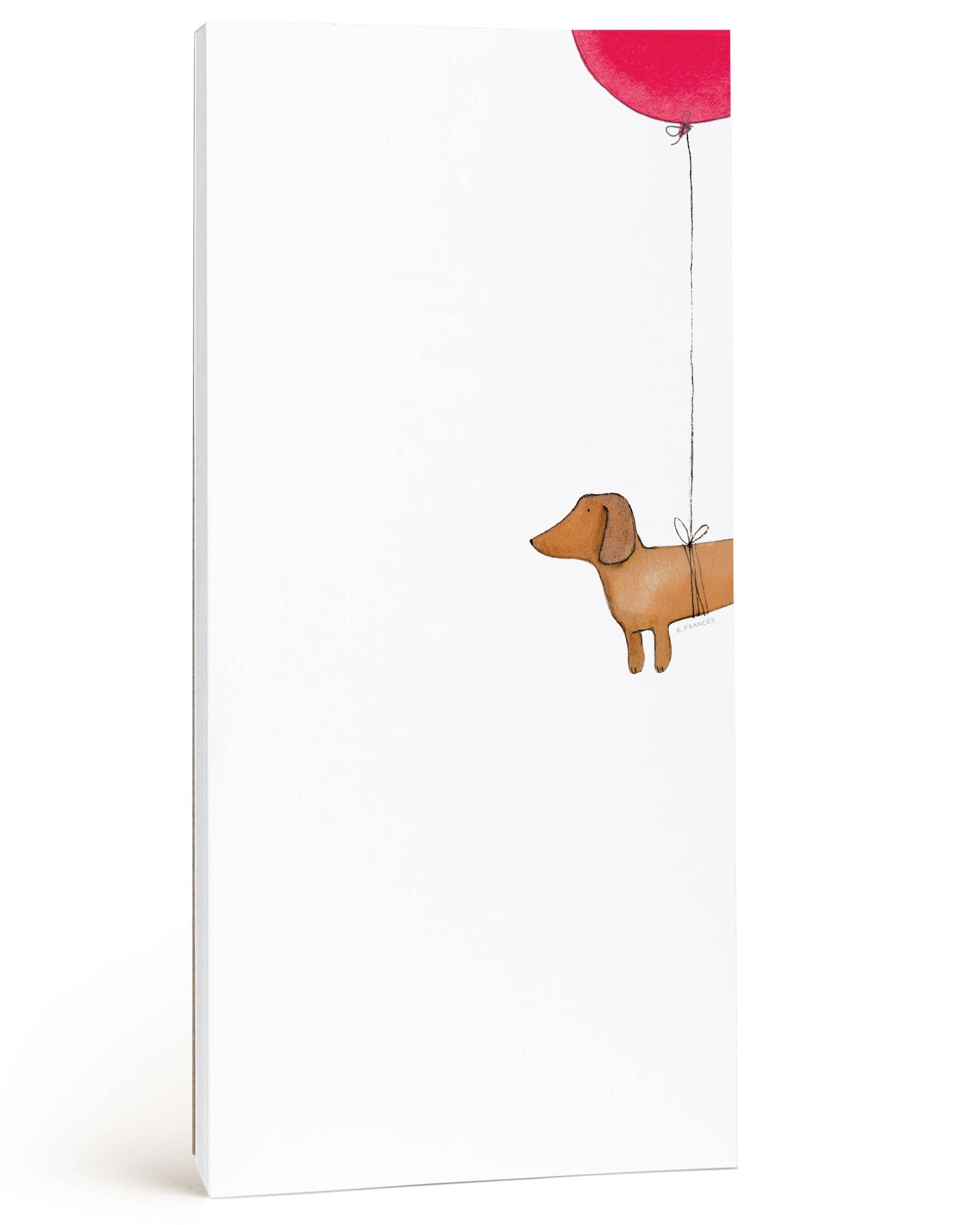 Wooden dog figurine with a red balloon on a white background
