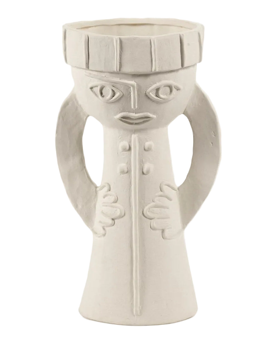 White ceramic vase with face design on a white background