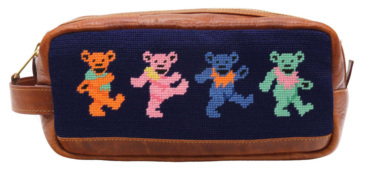 Toiletry bag with needlepoint design of four dancing bears on a white background