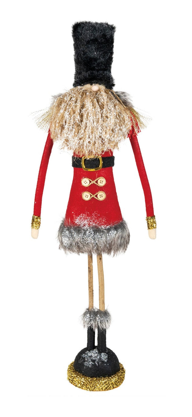 Decorative figure of a toy soldier with red uniform and black hat on a white background