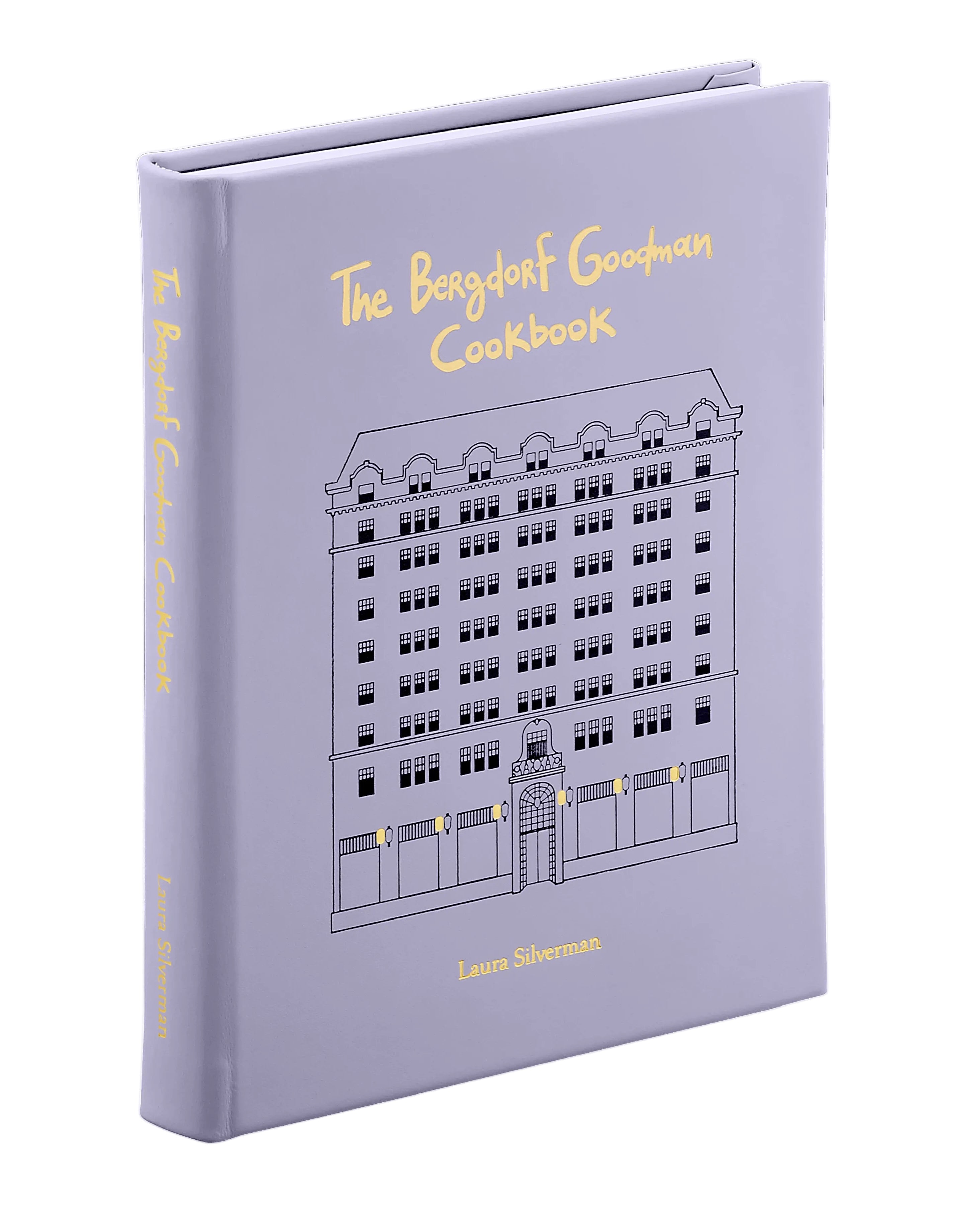 Purple cookbook titled 'The Bergdorf Goodman Cookbook' on a white background