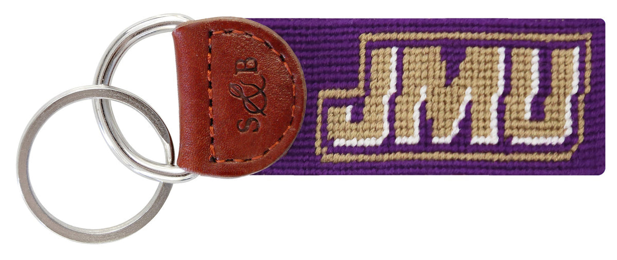 Keychain with 'JMU' logo on a purple strap with brown leather accent
