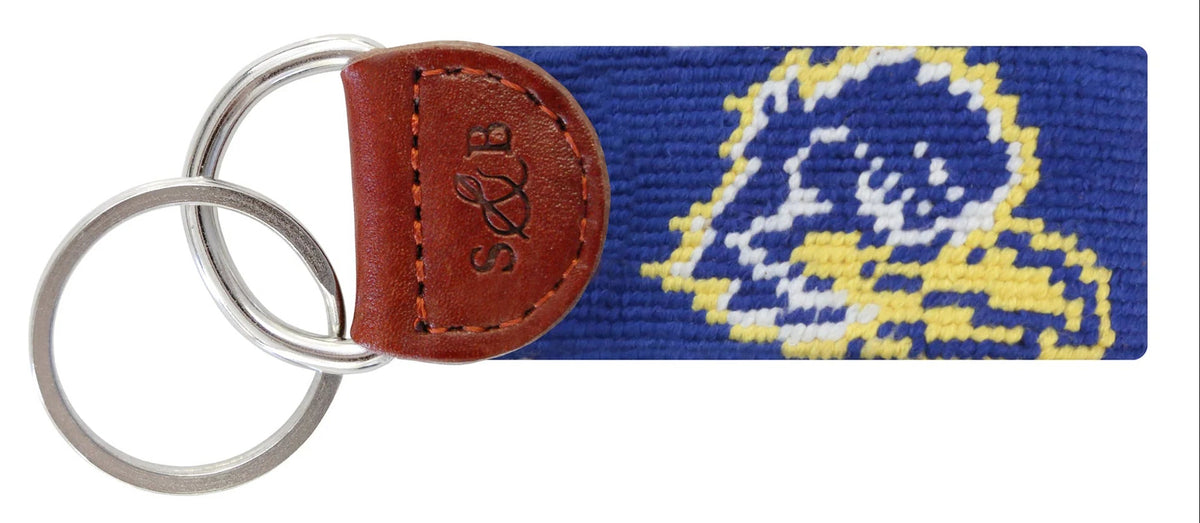 Keychain with needlepoint design and leather accent on a white background