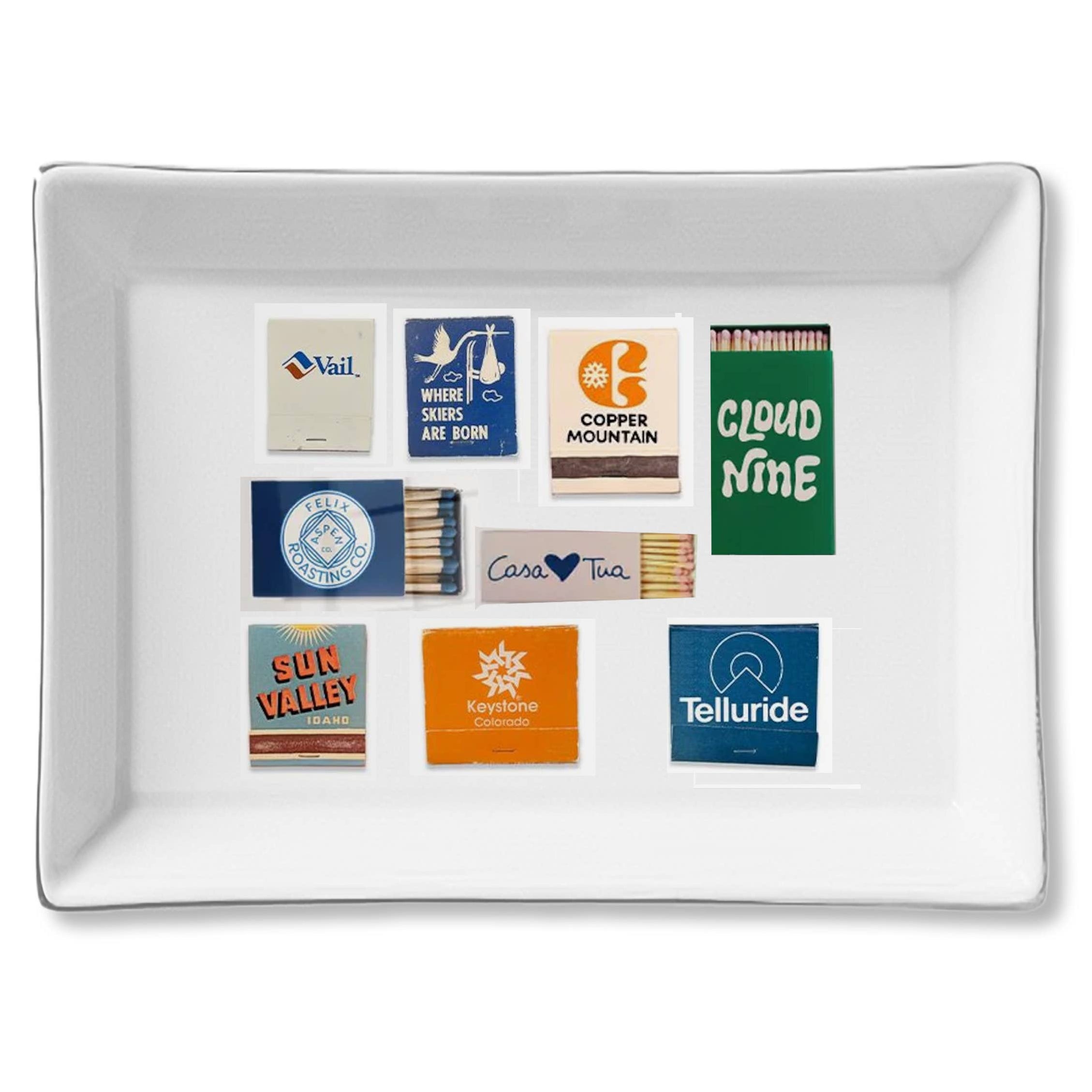 Rectangular white tray with matchbook covers featuring various locations on a white background