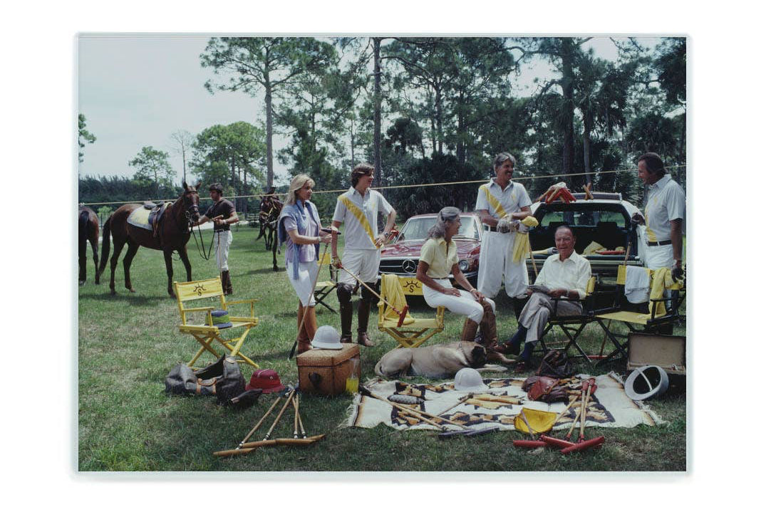 Group of people with polo equipment and a horse in an outdoor setting