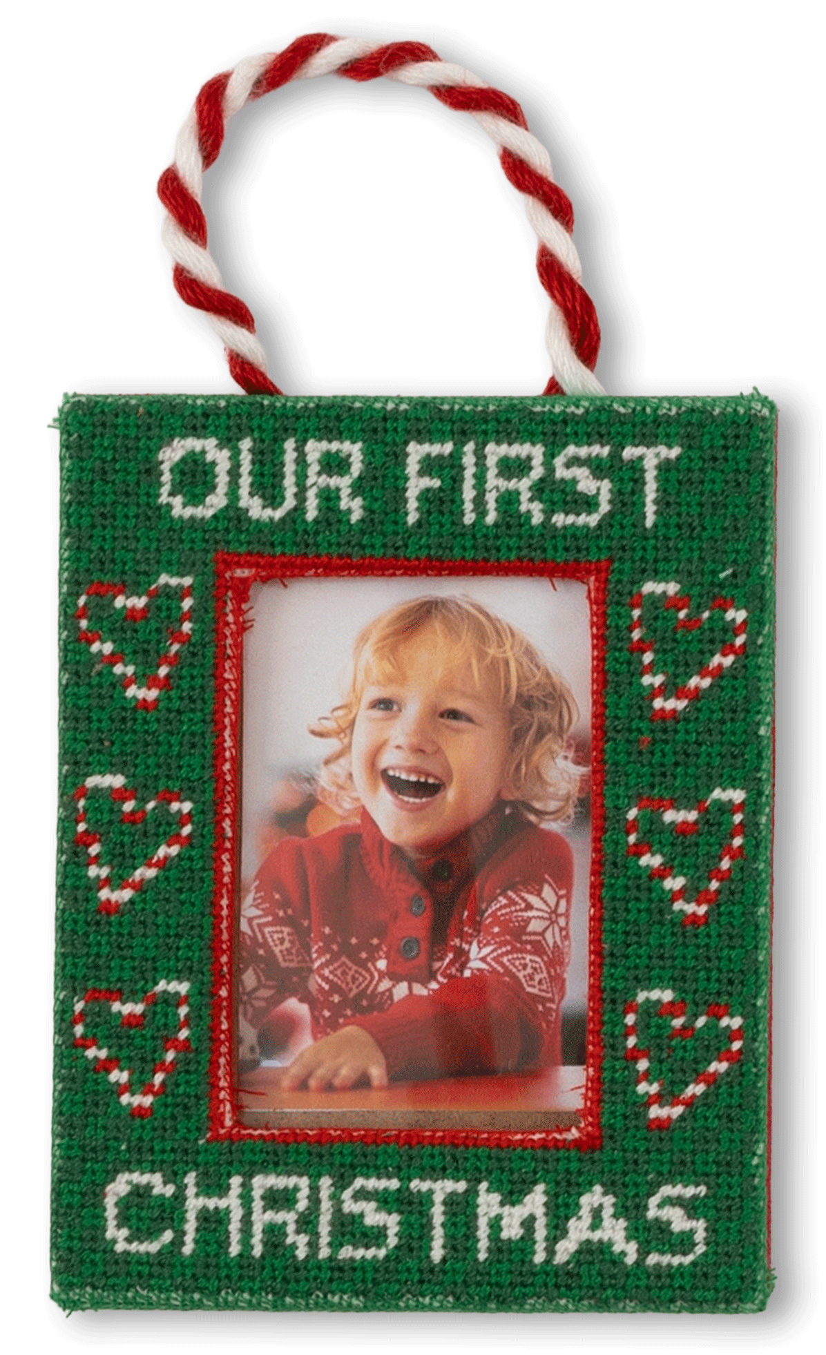Christmas ornament with 'Our First Christmas' text and a photo of a child on a white background