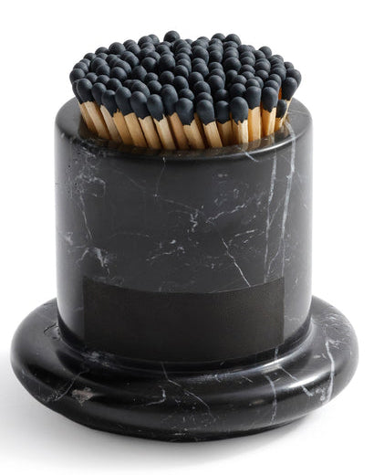 Black marble match holder with matches on a white background