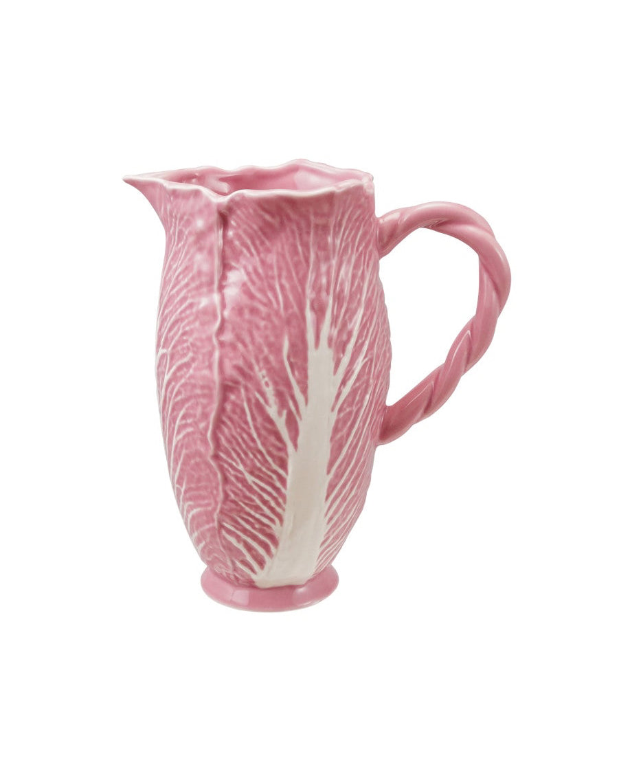Pink ceramic pitcher with leaf design on a white background