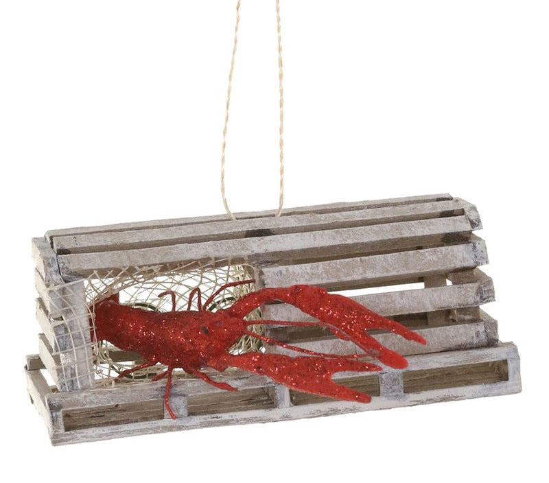 A lobster-shaped hanging ornament made from a galvanized metal clamshell with a red glitter lobster inside, suspended by a string against a white background.