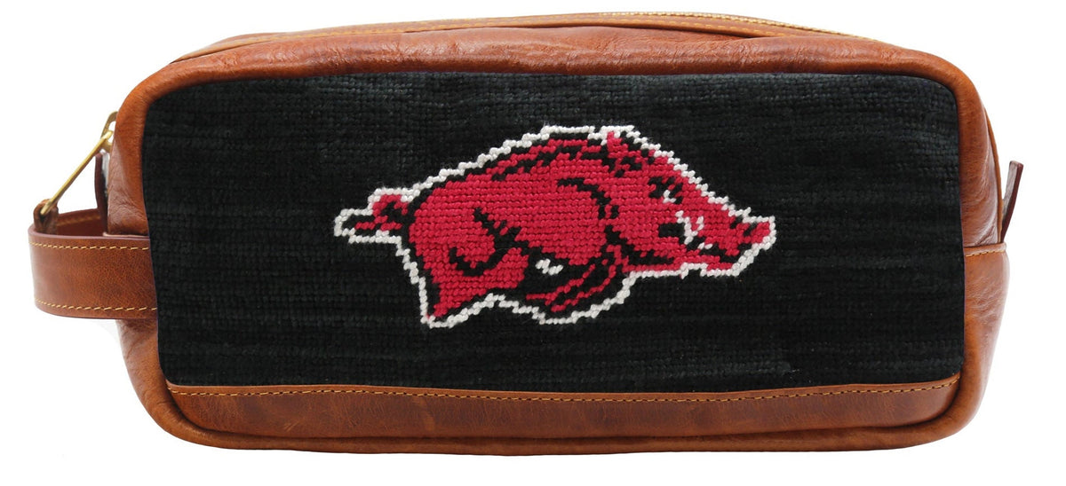 Black and brown dopp kit with a red and white logo on a white background
