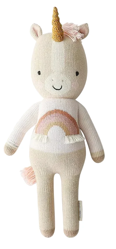 Knitted unicorn toy with a rainbow design on a white background