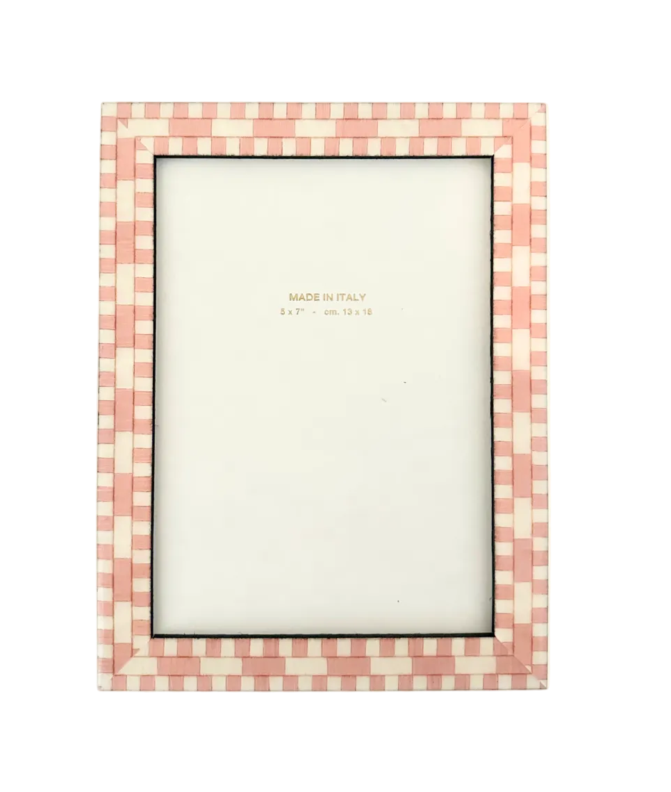 Checkered picture frame with a white center on a light pink background