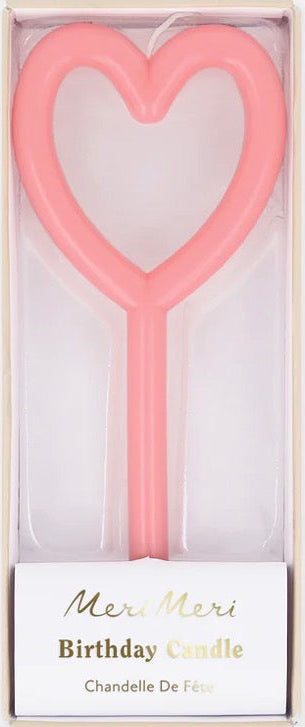 Heart-shaped pink birthday candle in a Meri Meri branded box on a white background
