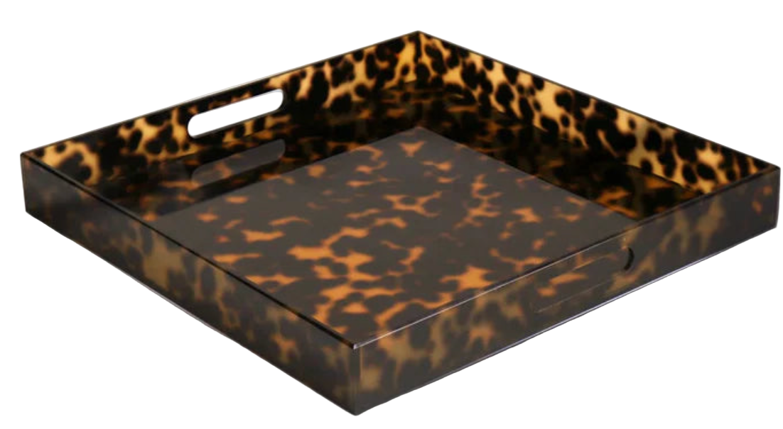A large square acrylic tray with a geometric pattern in dappled tones of amber and chocolate, featuring handles on the sides.