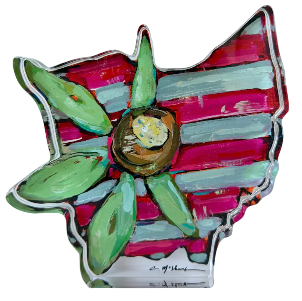 Colorful ceramic flower with green leaves on a white background