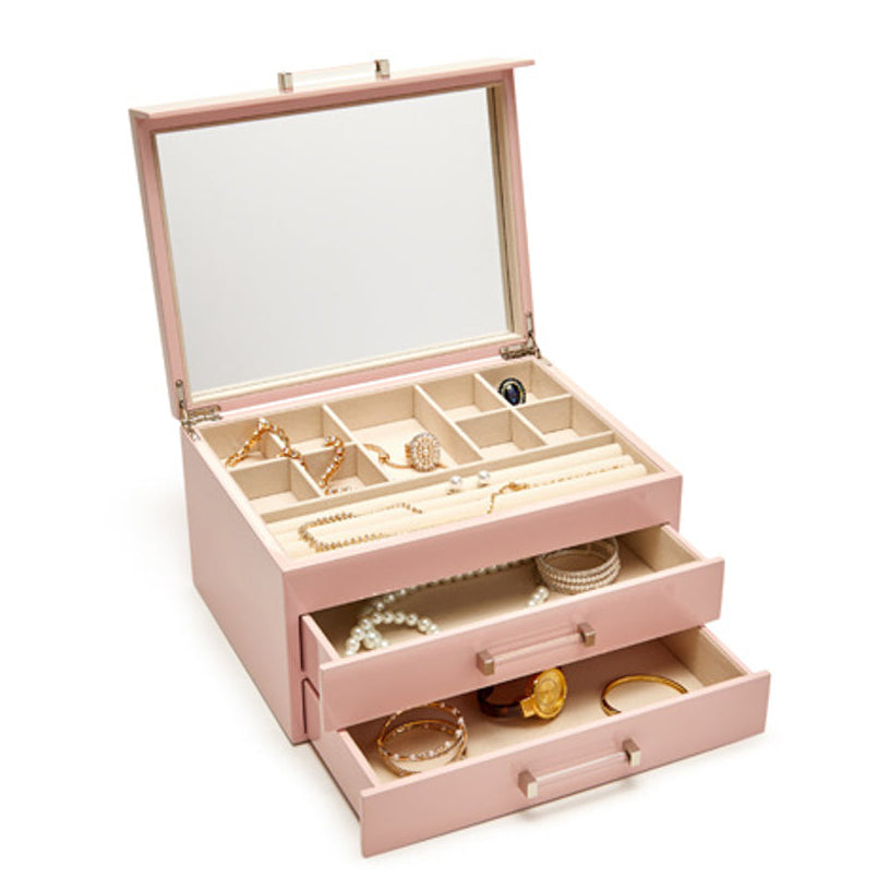 Pink jewelry box with jewelry inside on a white background