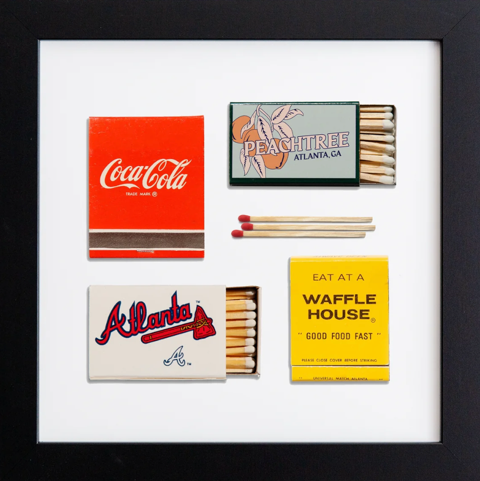 Framed display of matchbooks from Coca-Cola, Peachtree, Atlanta Braves, and Waffle House.