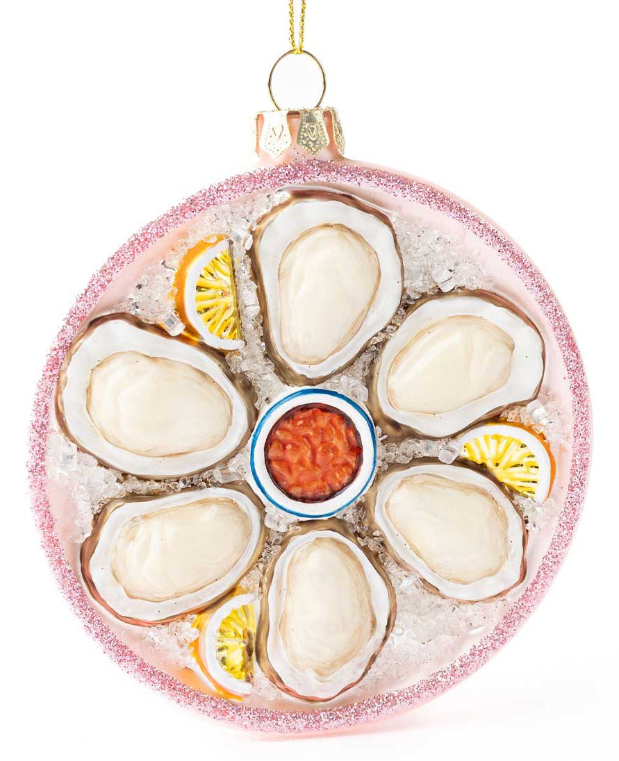 Decorative ornament resembling a plate of oysters with garnishes on a white background