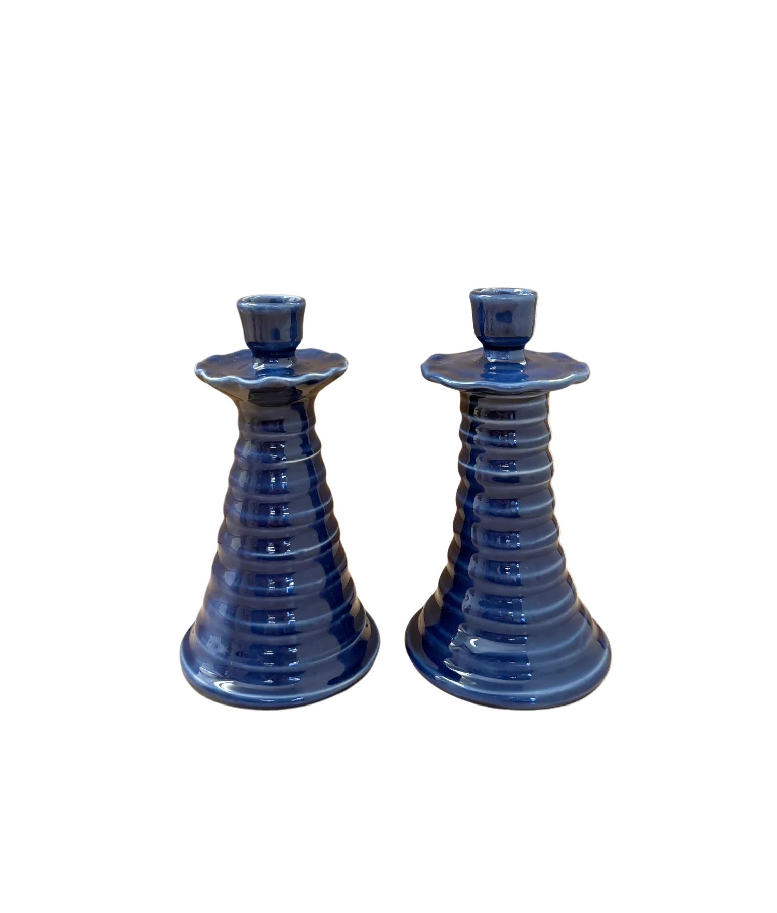 Two blue ceramic candle holders on a white background