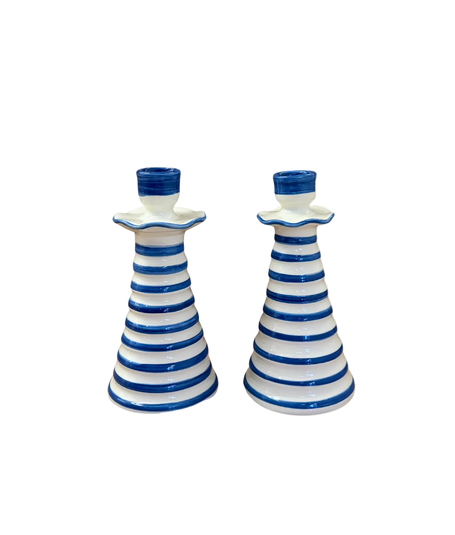 Two blue and white striped ceramic candle holders on a beige background