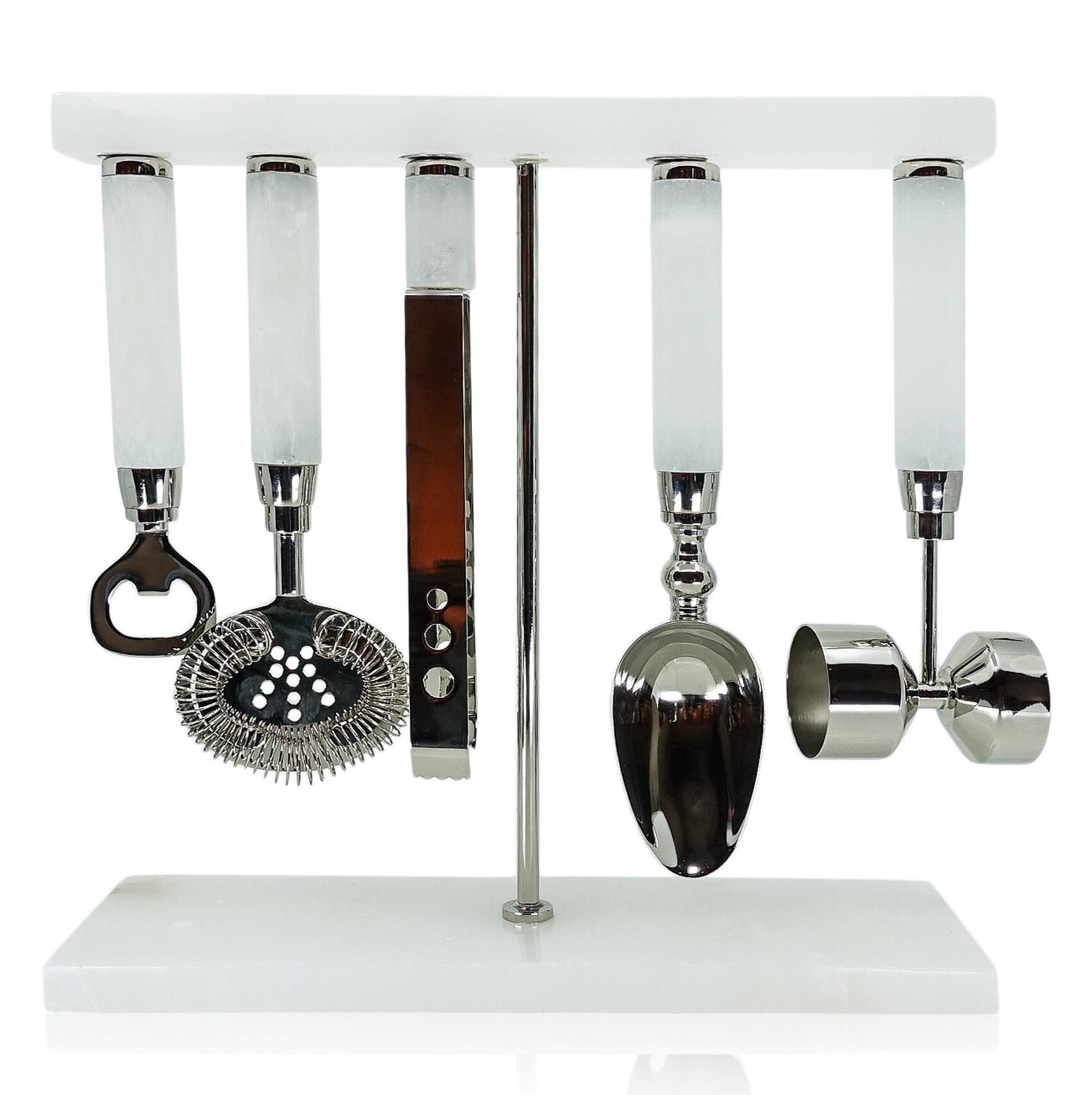 Set of bar tools including a bottle opener, strainer, jigger, and spoon on a white stand.