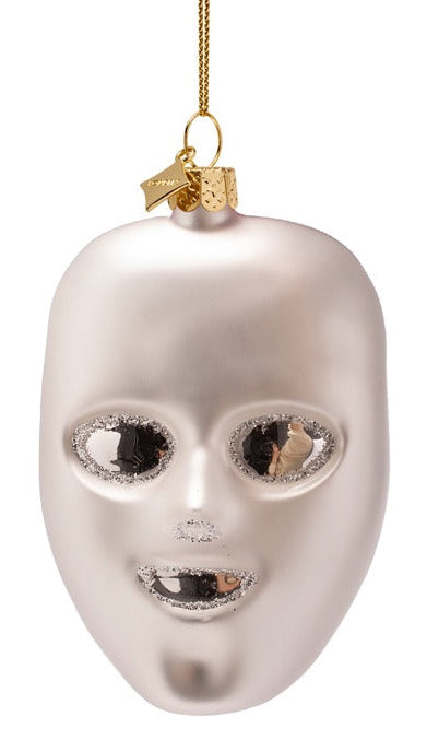 Silver mask ornament with gold accents on a white background