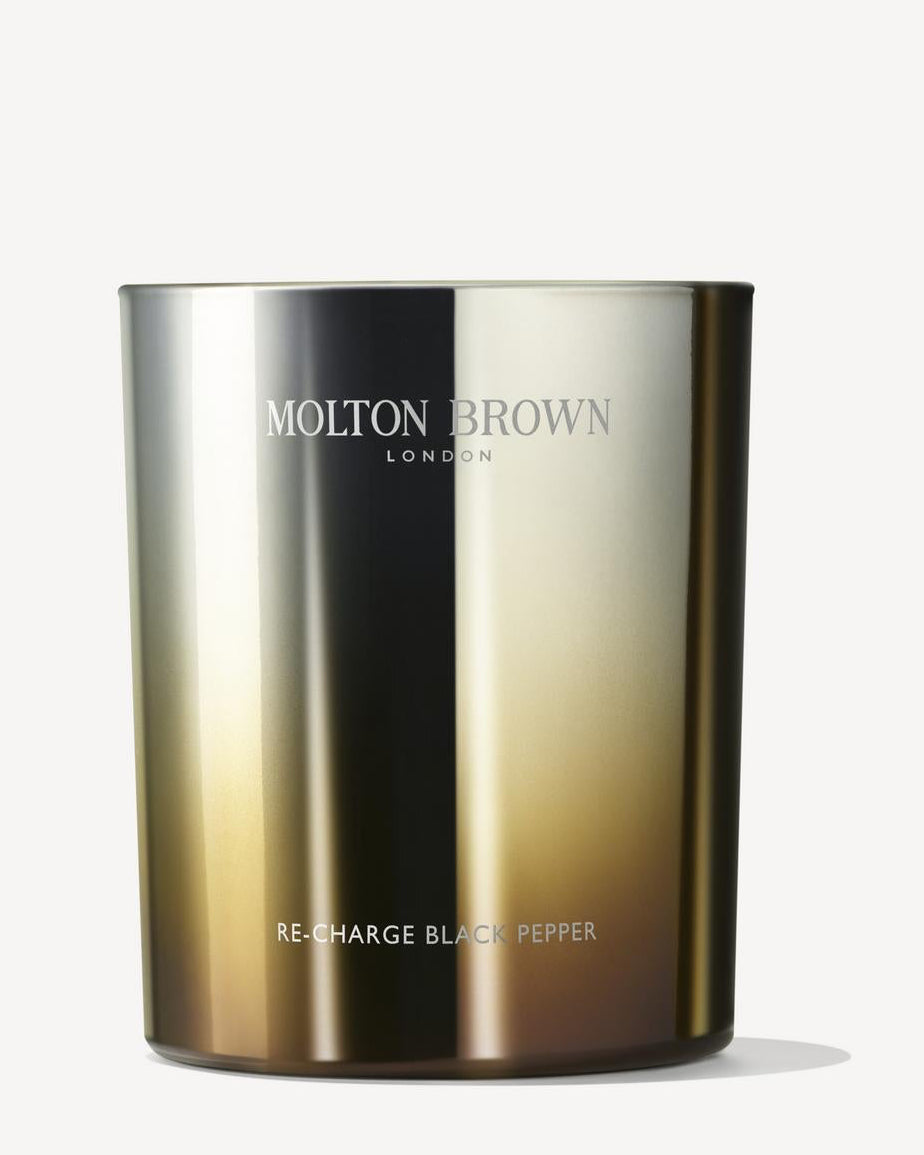 Molton Brown candle with gradient design on a white background