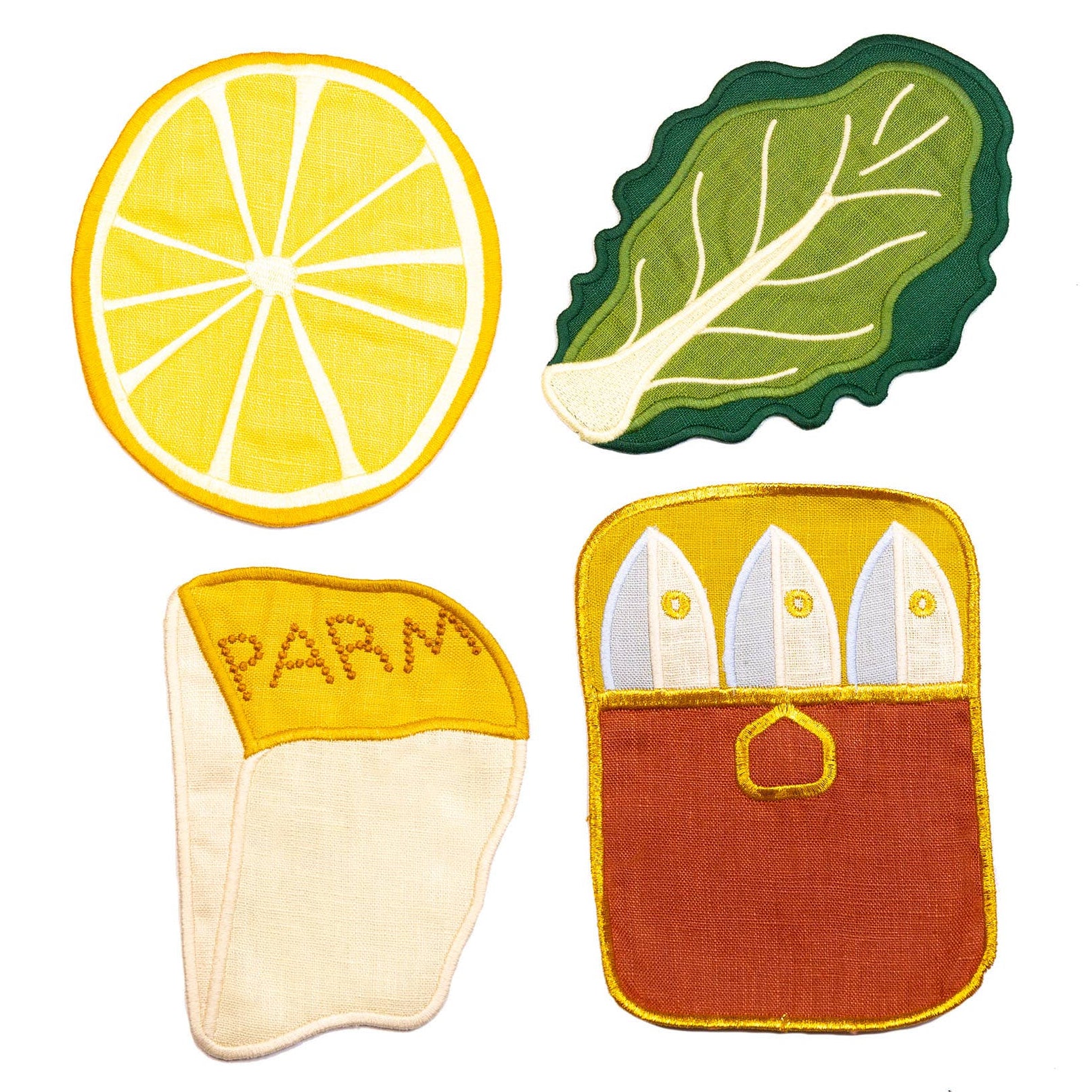 Set of colorful kitchen pot holders shaped like a lemon, leaf, Parmesan cheese, and baguette on a white background.