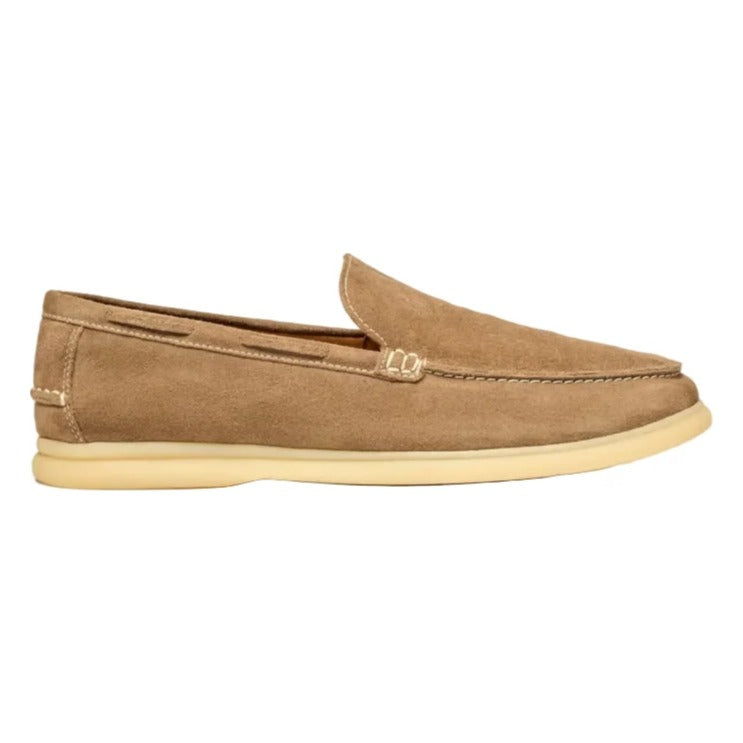Beige loafer shoe on a light beige background