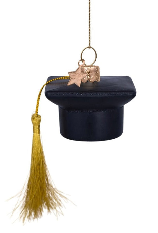 Decorative graduation cap ornament with tassel on a white background