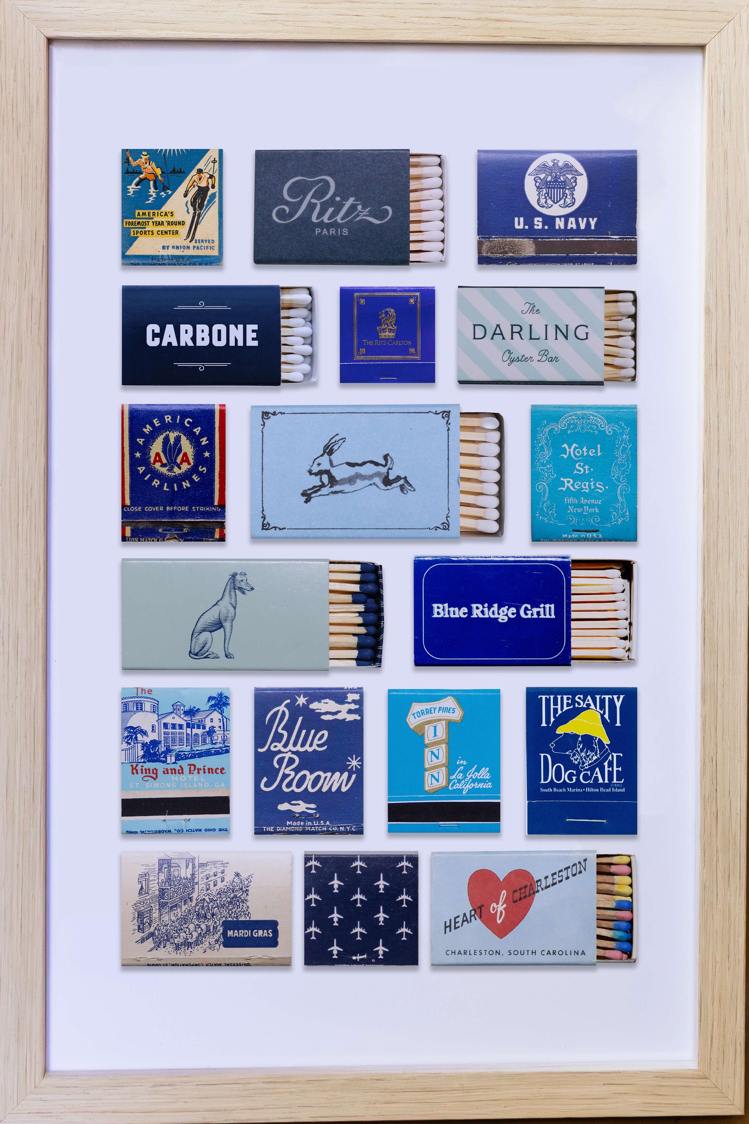 Framed collection of matchbook covers on a wooden surface