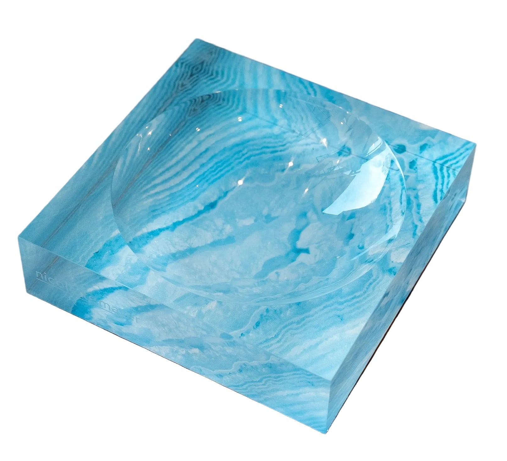 Blue marbled rectangular tray on a wooden surface with a blurred background