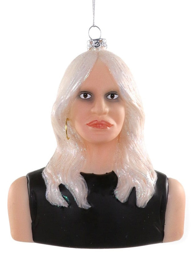 A bust-shaped Christmas ornament depicting a woman with long white hair, a black sleeveless top, and small gold hoop earrings, hanging by a silver string against a white background.