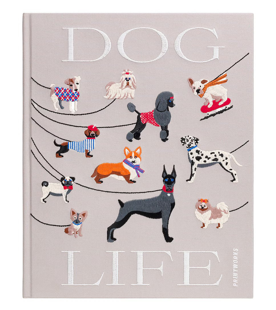 A hardcover book titled 'DOG LIFE' by Peter H. Reynolds, featuring a light gray cover decorated with various illustrated dog breeds in different outfits and poses.