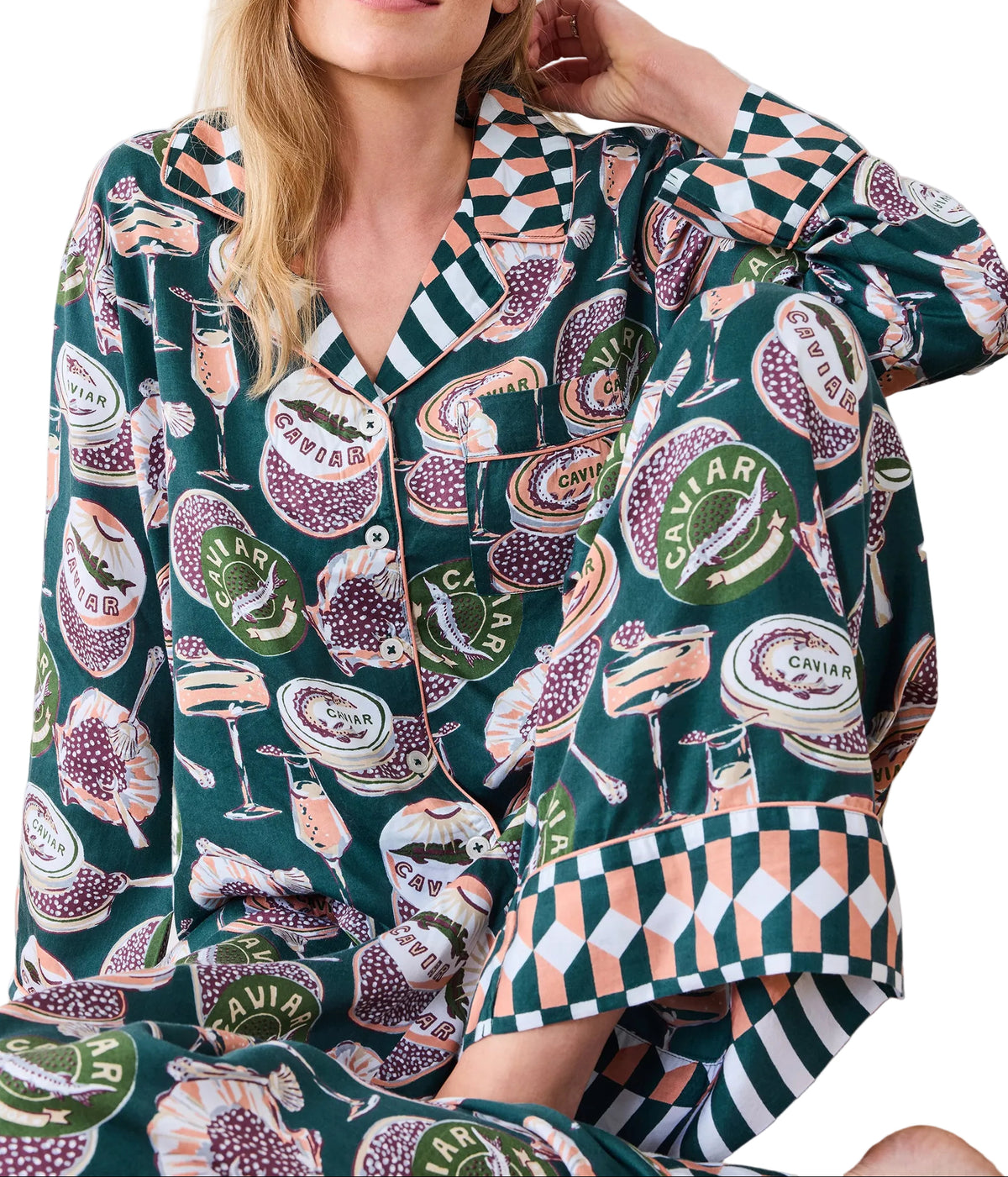 Woman wearing a patterned pajama set with a green background