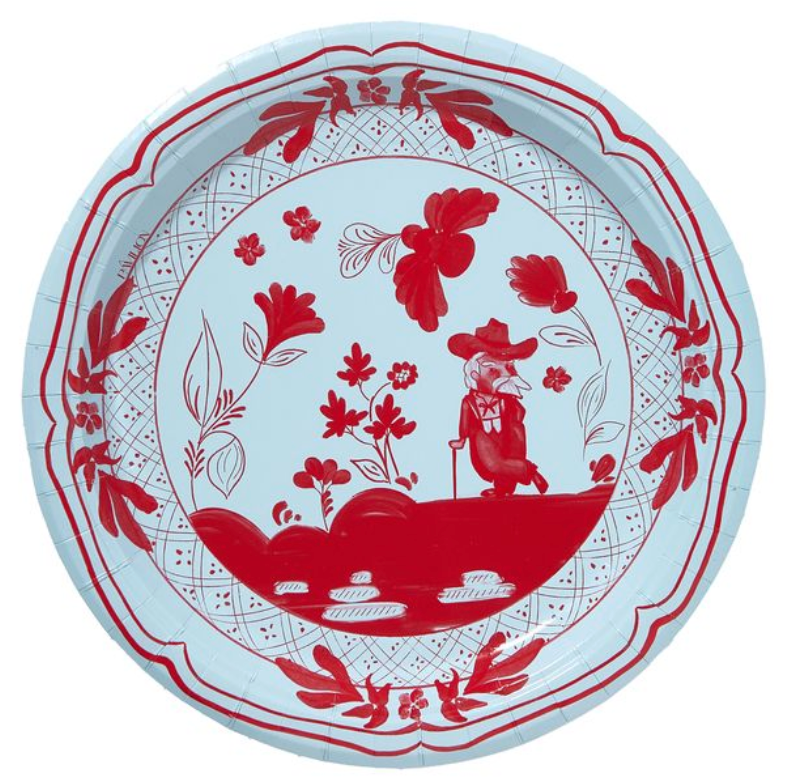 A round paper plate featuring a red and white hand-painted style illustration of a cowboy riding a horse, surrounded by floral and leaf patterns.