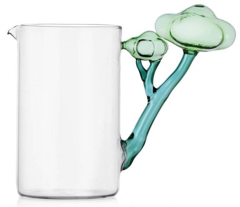 Clear glass pitcher with a turquoise handle on a white background