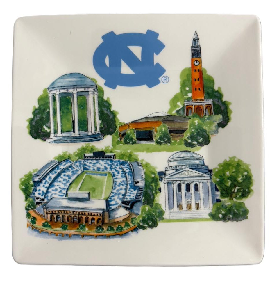 A square off-white ceramic plate featuring a colorful illustration of North Carolina University landmarks, including the UNC logo, a classical building, a stadium, and a clock tower, on a plain white background.