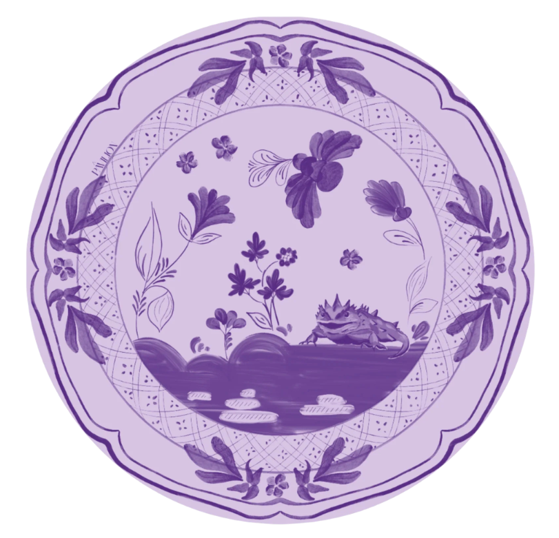 A round decorative plate or dish with a scalloped edge, featuring a purple and lavender floral and landscape design on a white background.
