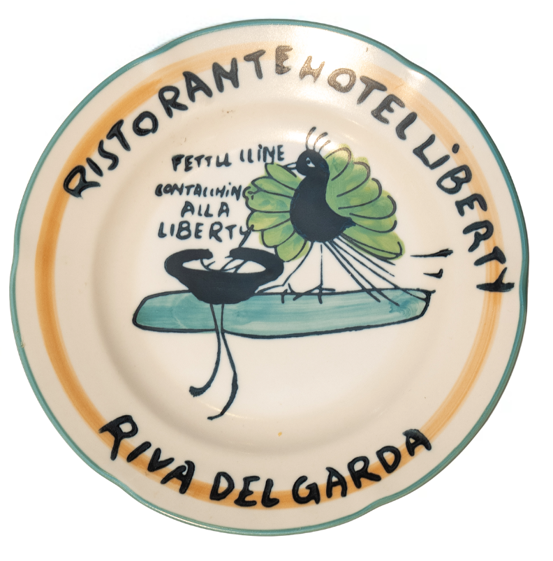 Decorative plate with 'Ristorante Hotel Liberty' text and a bird illustration on a white background