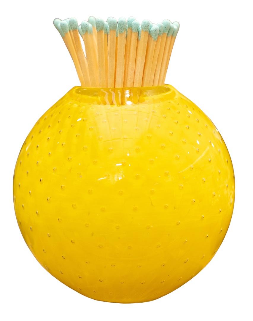 A bright yellow textured glass vase filled with wooden matches that have mint green tips, isolated on a white background.