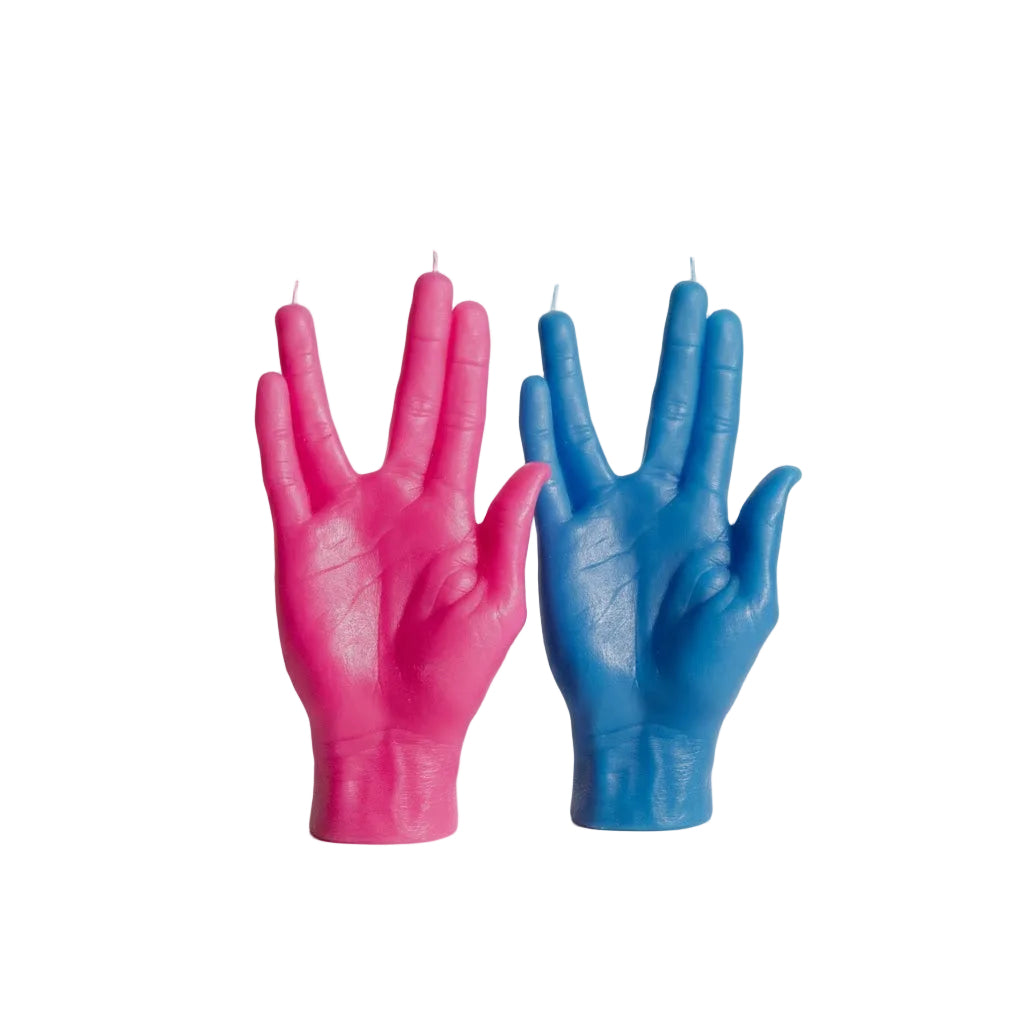 Pink and blue hand-shaped candles on a white background