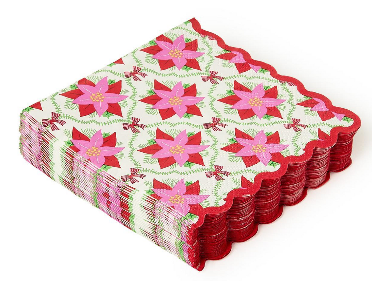 Stack of red and pink floral patterned paper plates on a white background