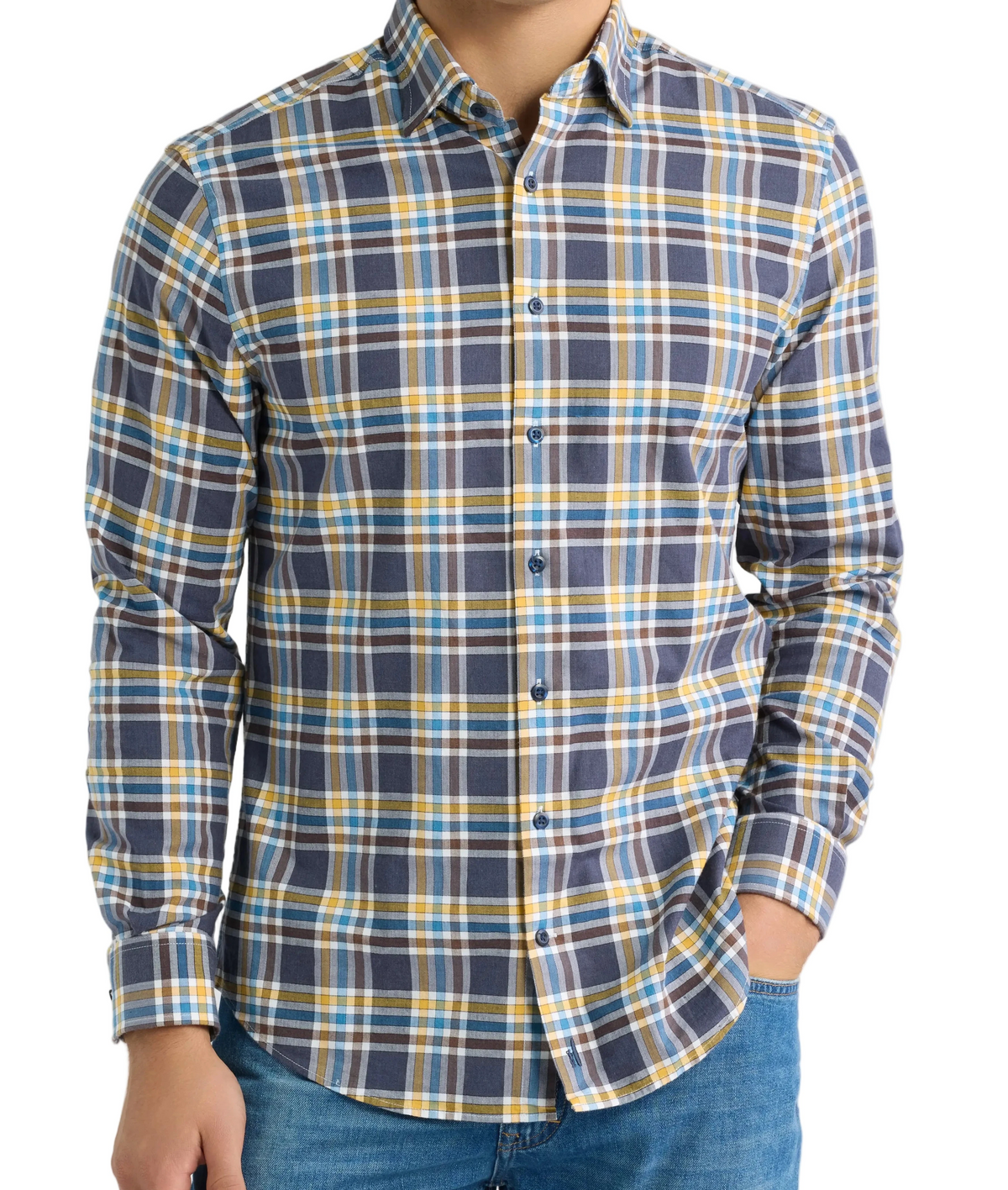 A man wearing a long-sleeve button-down plaid shirt in navy blue, yellow, and white, paired with blue jeans, against a plain white background.